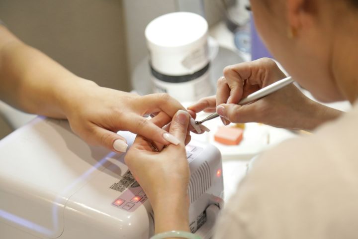 Manicure - a woman getting her nails done at a nail salon