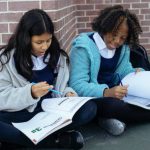 Kids Corner - Multiethnic pupils reading textbooks and doing exercises