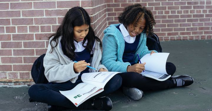 Kids Corner - Multiethnic pupils reading textbooks and doing exercises