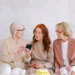 Tech - Women Sitting on Grey Sofa