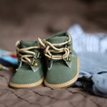 Kids Clothes - Baby's Green and Beige Sneakers on Brown Textile