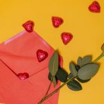 Gift Ideas - Red Envelope and Red Rose On Yellow Background