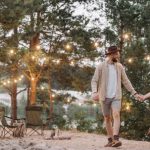 Romantic Evening - Man and Woman Standing on Brown Sand Near Body of Water