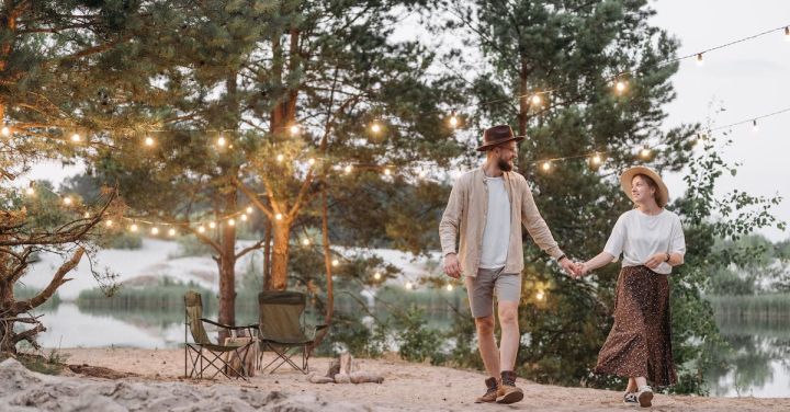 Romantic Evening - Man and Woman Standing on Brown Sand Near Body of Water