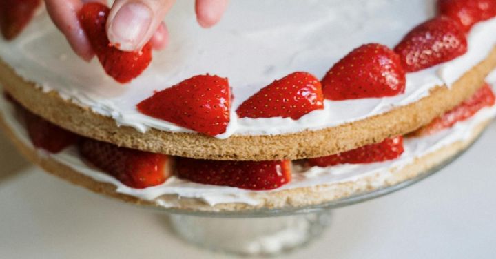 Foodie Favorites - Person Holding Strawberry Cake on White Ceramic Plate