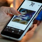 Shopping - Person Using Black And White Smartphone and Holding Blue Card