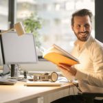 Tech Gadgets - Photo of Man Holding a Book